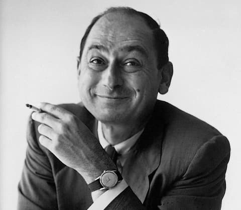 A portrait of George Nelson holding a cigarette