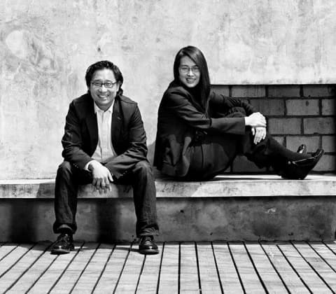 Lyndon Neri and Rossana Hu sitting on a bench